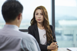 young asian business woman being interviewed by hr manager in modern corporate office